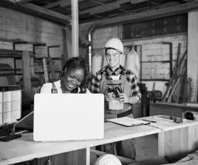 Workshop owners looking at laptop 
