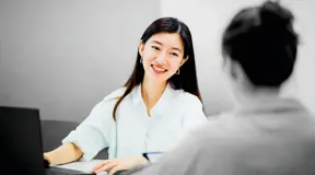 Person smiling at desk 