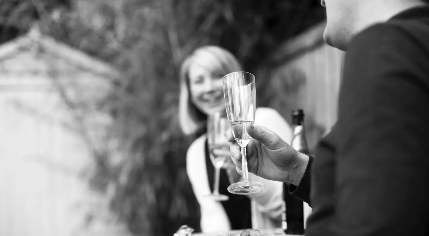 Couple drinking champagne in garden 