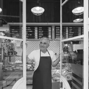 Business owner looking out of shop window 