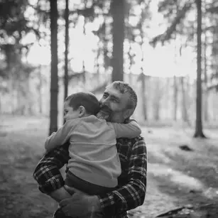 Dad holding child in arms 