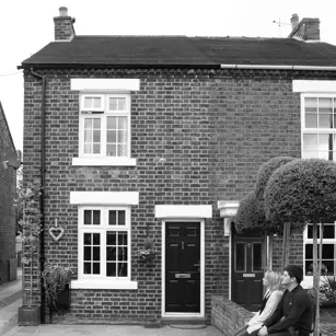 Couple sitting outside new home 