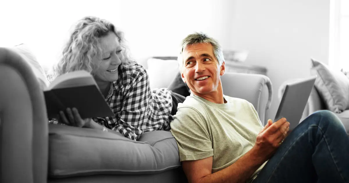 Couple on the sofa reviewing their finances