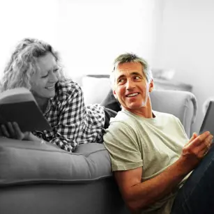 Couple on the sofa reviewing their finances