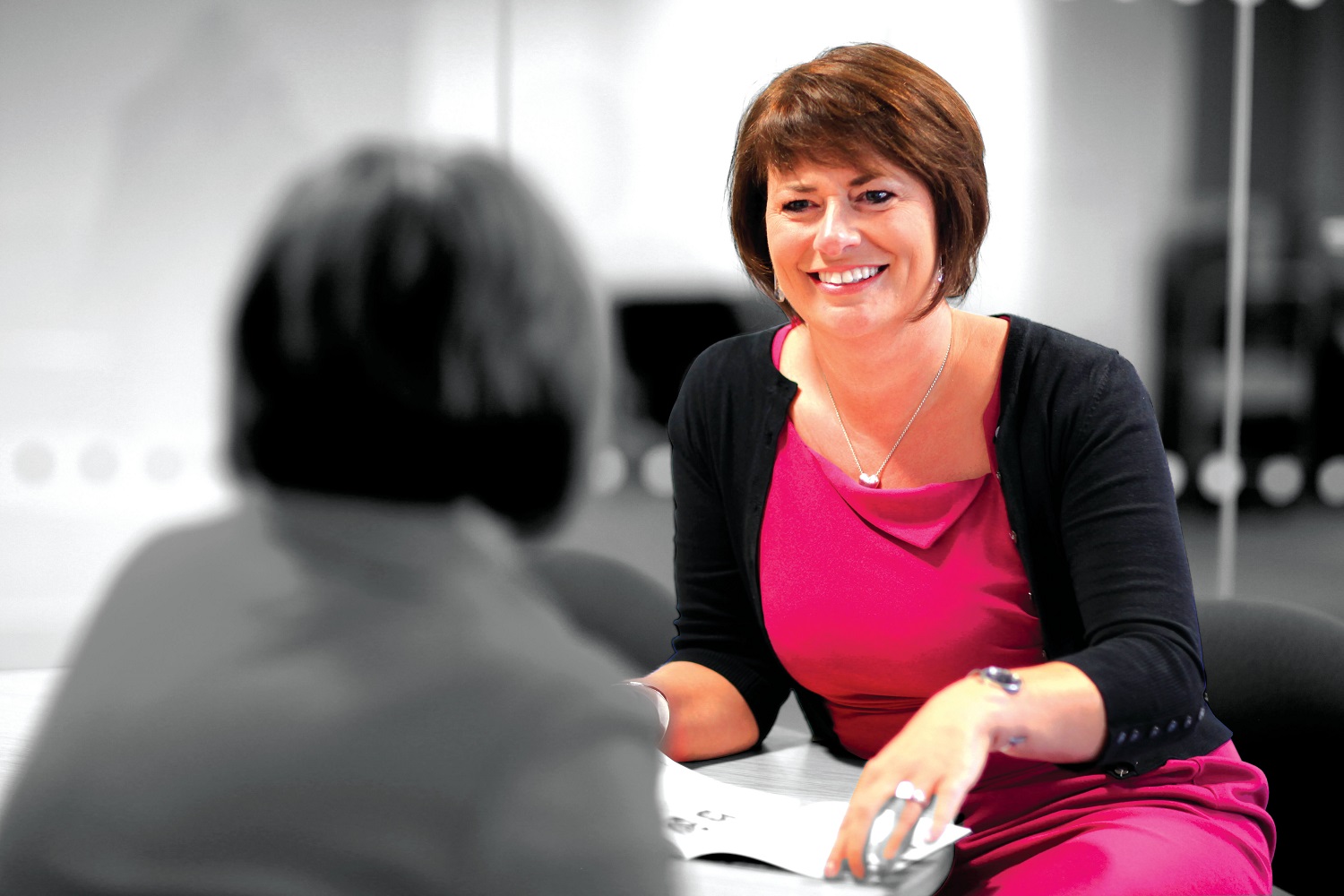 Person smiling in meeting 