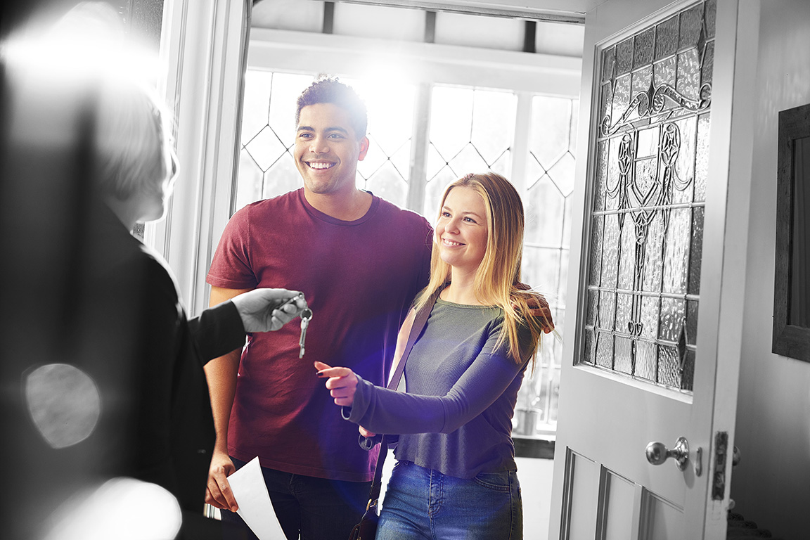 Couple collecting keys to their new home