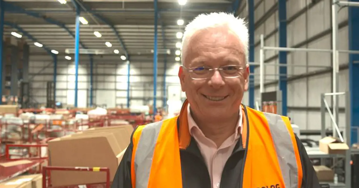 Close-up of Neil Daniells, chief executive of Prolog Fulfilment, standing in a warehouse wearing a high visibility vest.