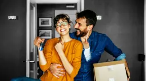 Happy couple moving into their new home