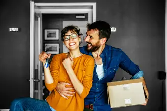 Happy couple moving into their new home