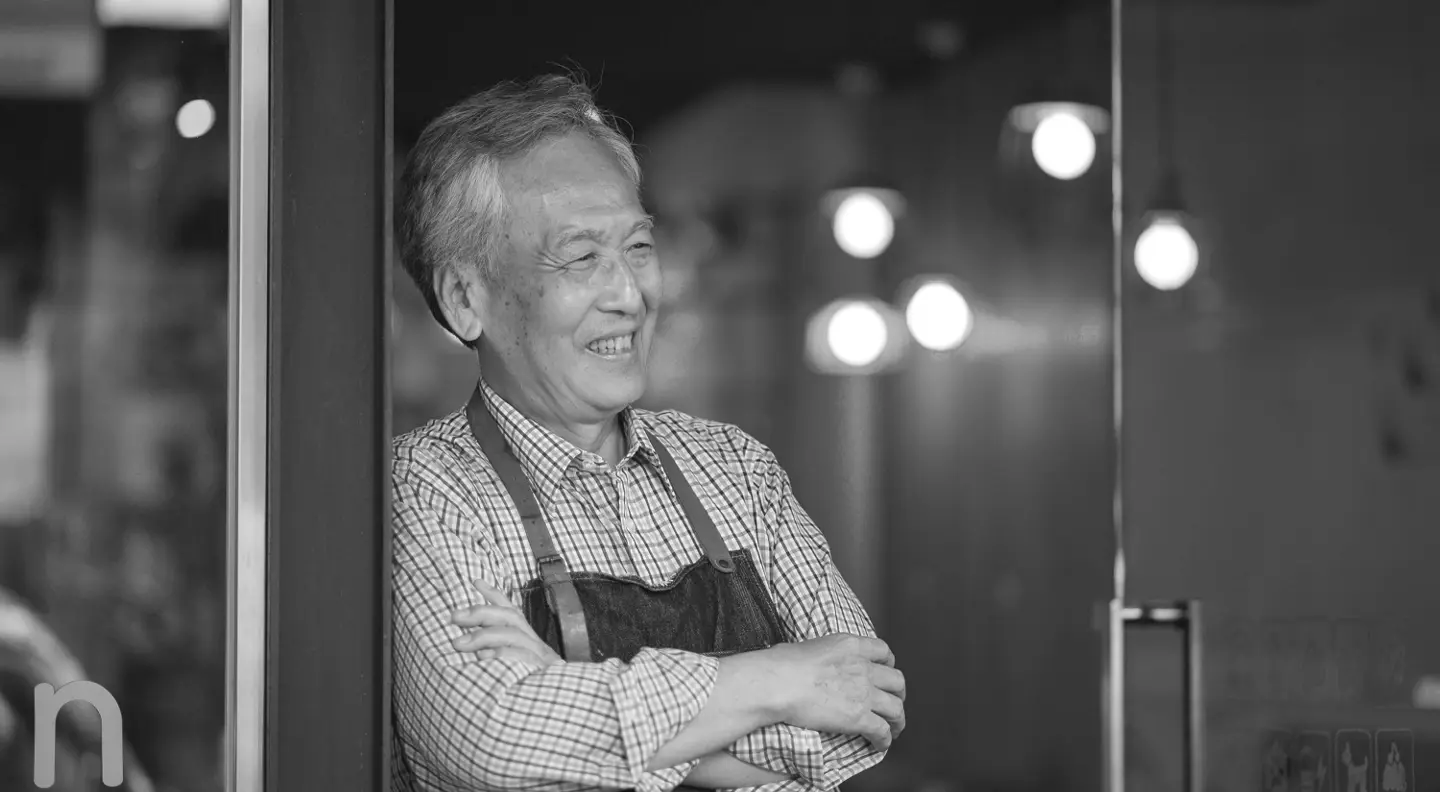 Business owner smiling outside shop