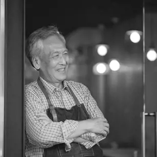 Business owner smiling outside shop