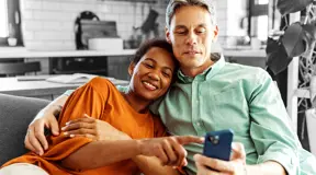 Happy couple looking at something on a phone