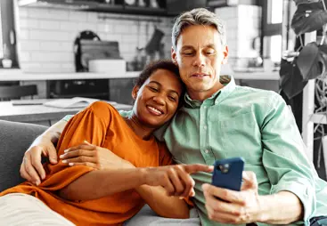 Happy couple looking at something on a phone