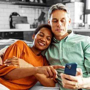 Happy couple looking at something on a phone