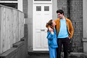 Young couple outside their new home