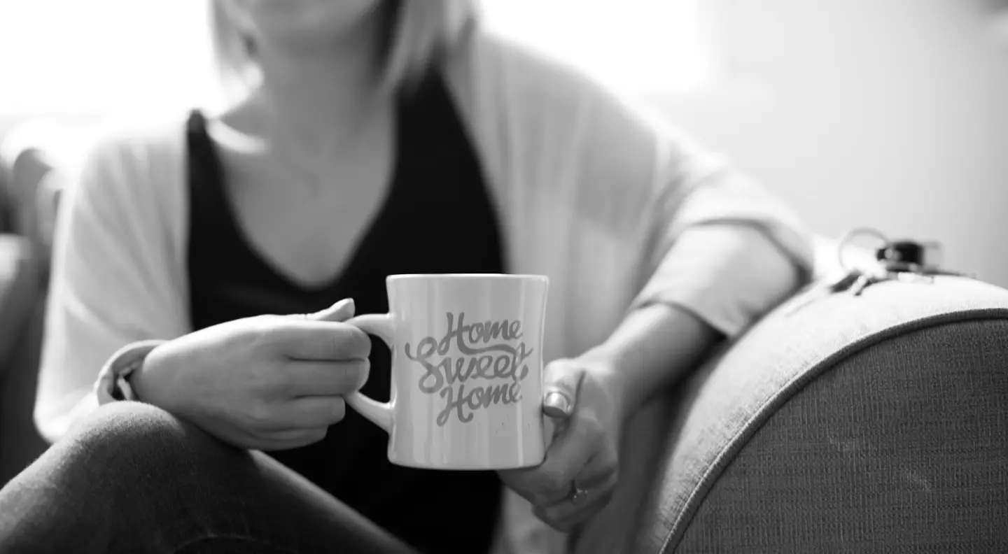 Person holding home sweet home mug 