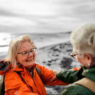 Friends hugging on beach