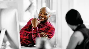 Person smiling at desk 