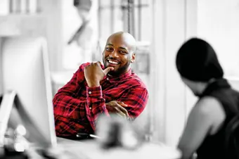 Person smiling at desk 