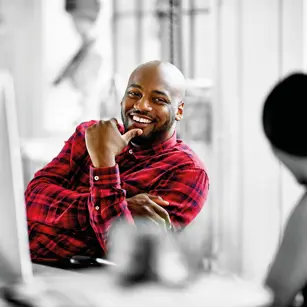 Person smiling at desk 
