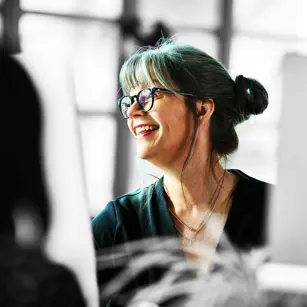 Person smiling at desk 