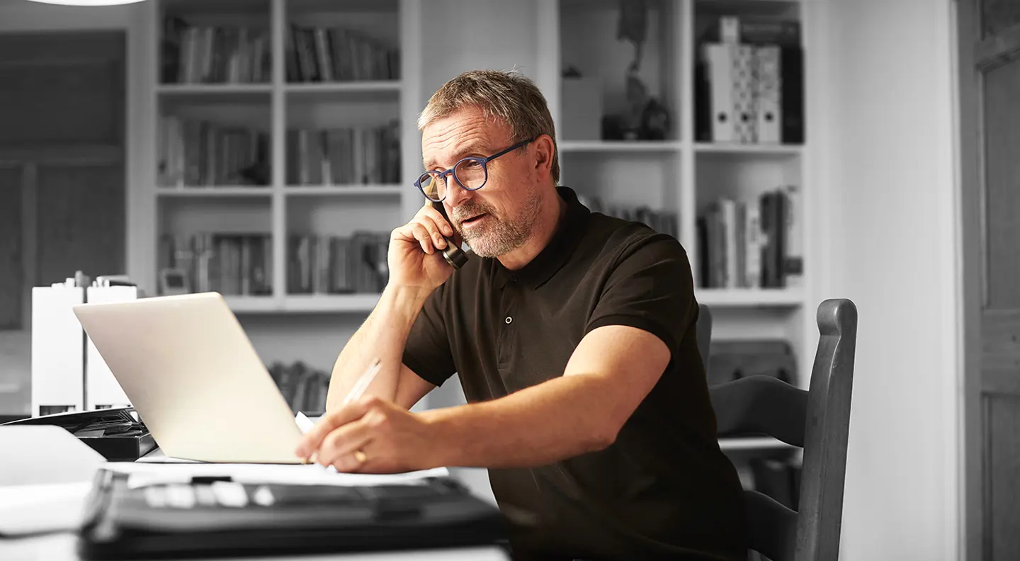 Man on phone and laptop