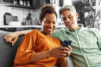 Smiling couple looking at something on a phone