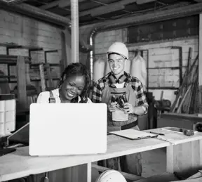 Workshop owners looking at laptop 