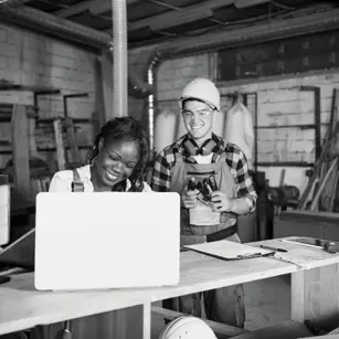 Workshop owners looking at laptop 