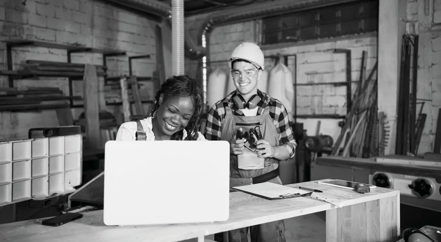 Workshop owners looking at laptop 
