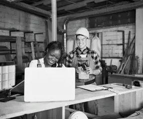 Workshop owners looking at laptop