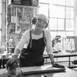 Workshop mechanic using sander 