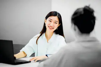 Person smiling at desk 
