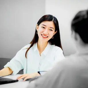Person smiling at desk 