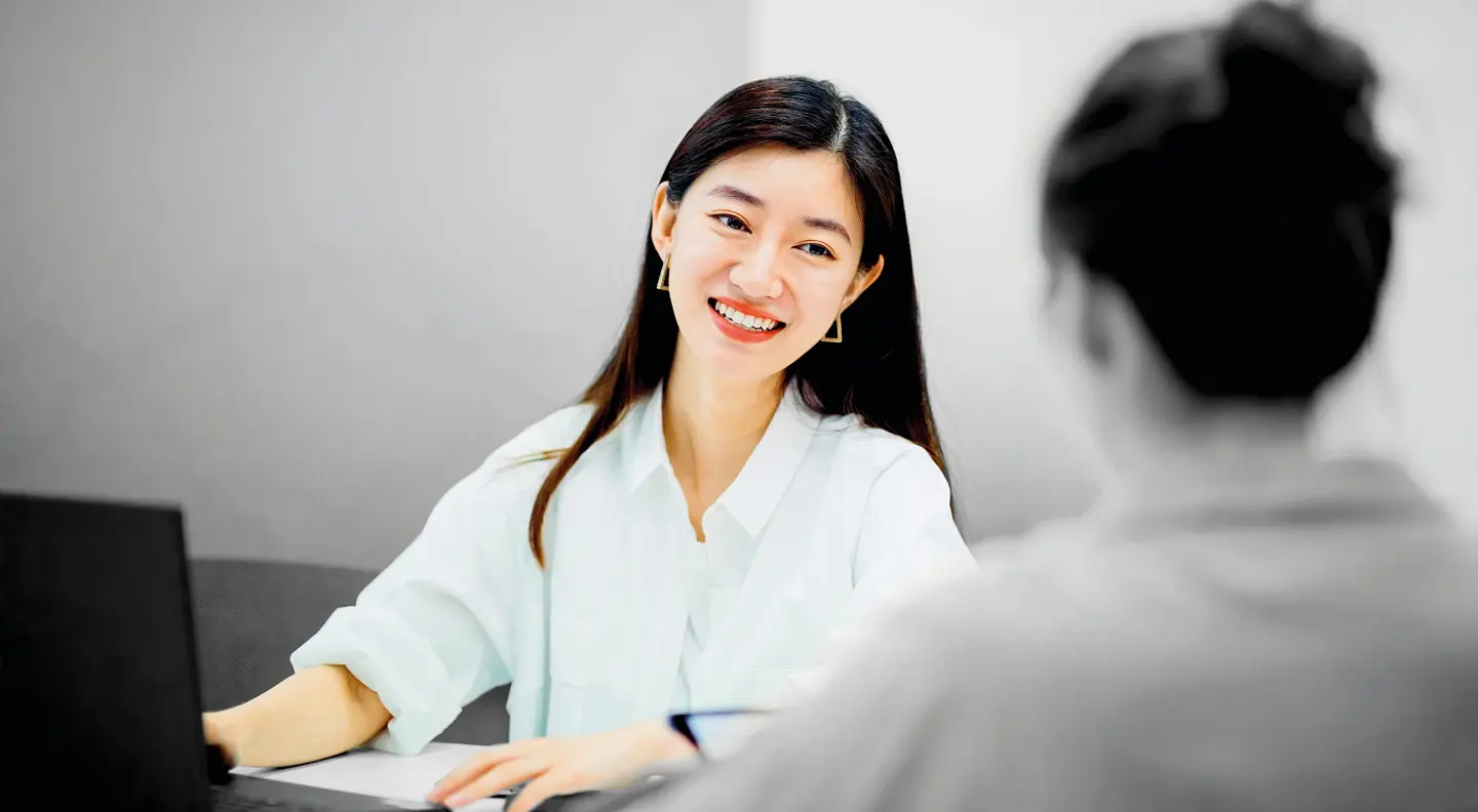 Person smiling at desk 