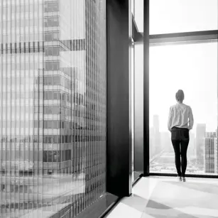 Person looking out from high rise building 