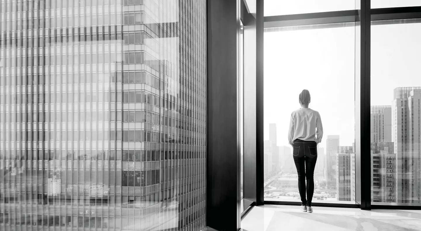Person looking out from high rise building 