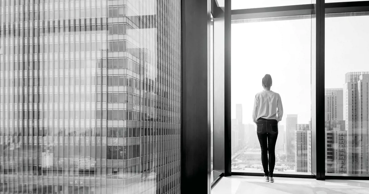 Person looking out from high rise building 