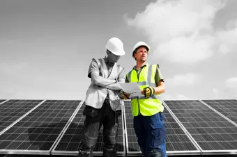 Engineers looking at solar panel plans