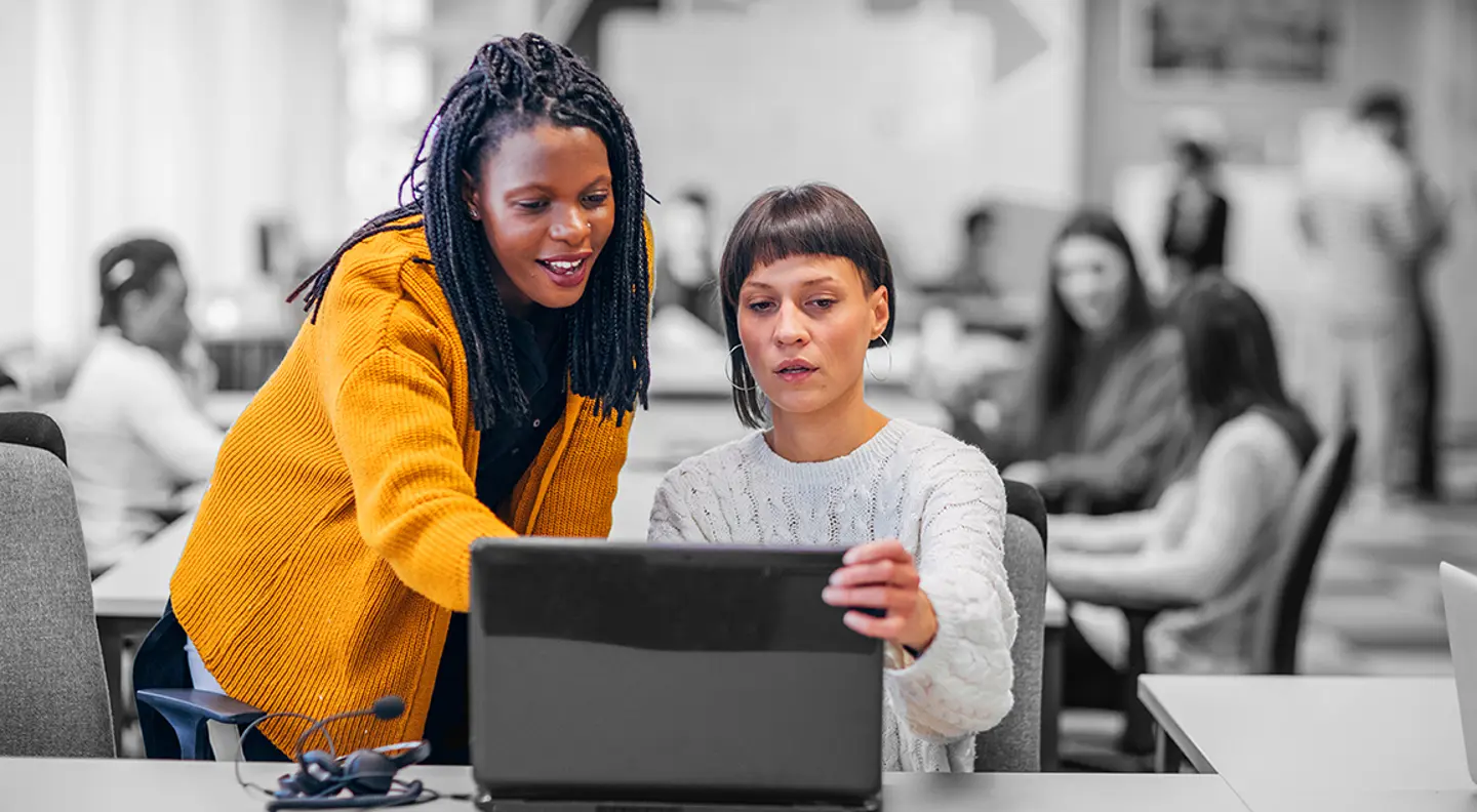 two women at a laptop