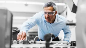 Person in factory wearing protective goggles
