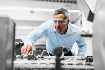 Person in factory wearing protective goggles