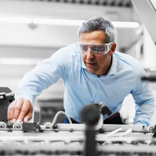Person in factory wearing protective goggles