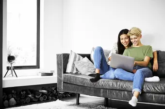 Couple on their laptop on sofa