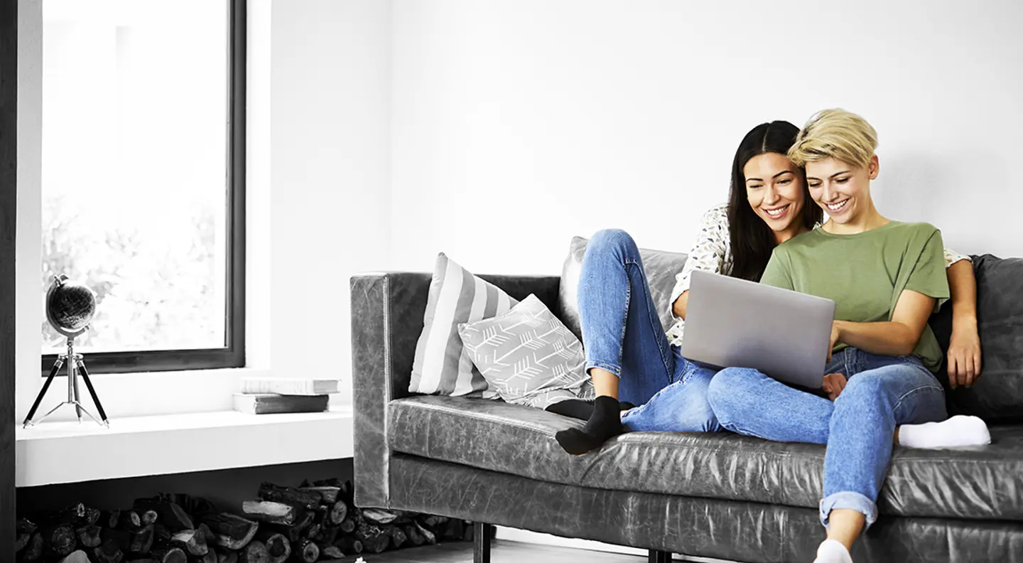 Couple on their laptop on sofa