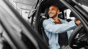 Person trying out a car in dealership