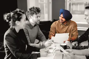 People smiling and laughing in a meeting