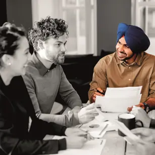 People smiling and laughing in a meeting