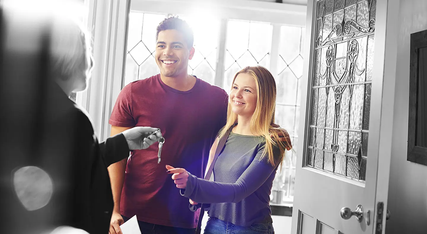Couple collecting keys to their new home