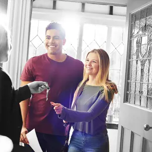 Couple collecting keys to their new home